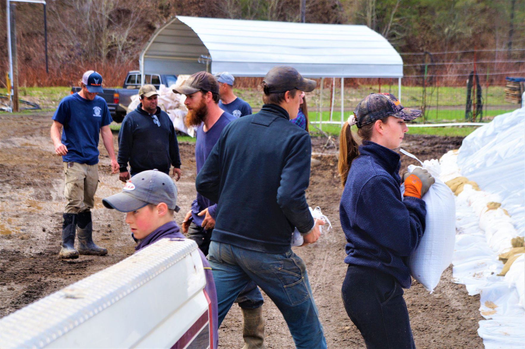 Volunteers move sandbags